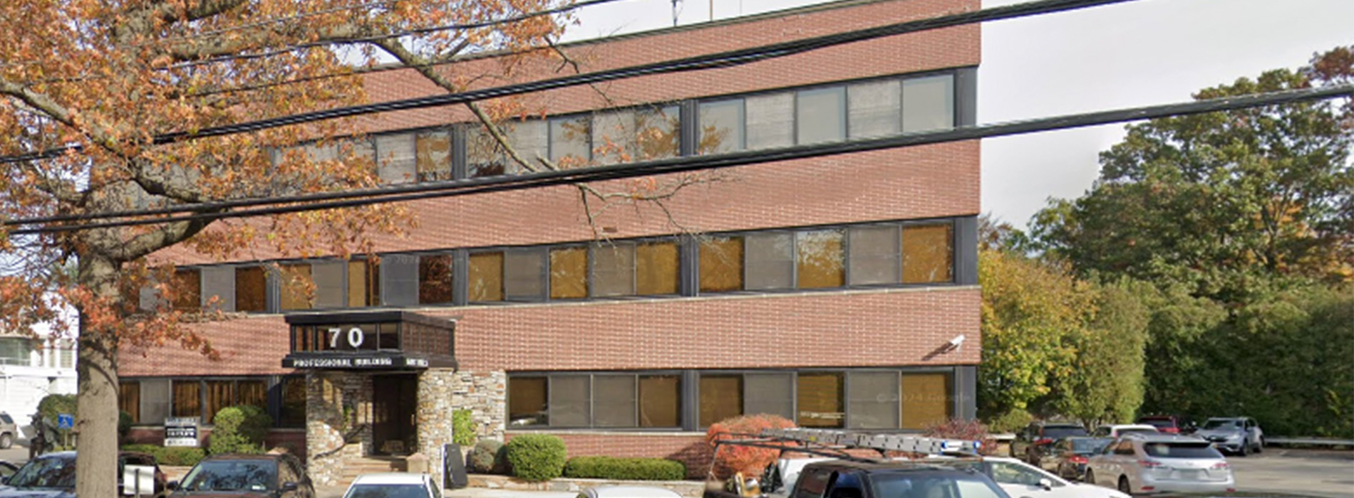 The image is a photograph of a multi-story brick building with a prominent sign that reads  CENTRE STATE BANK  on its facade.