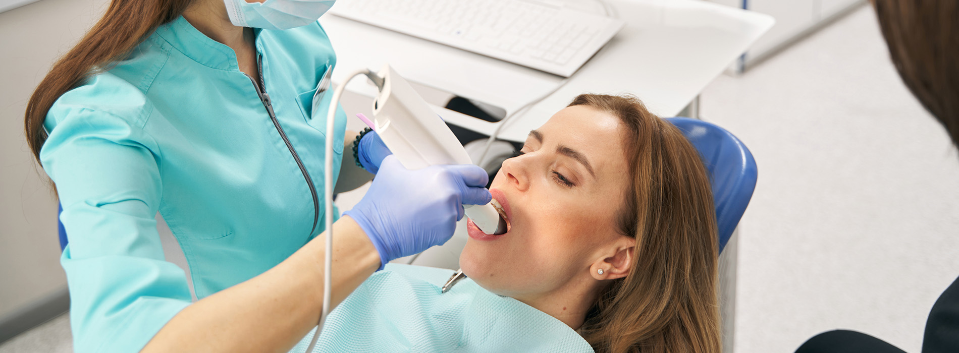 A dental hygienist cleaning a patient s teeth in a professional setting.