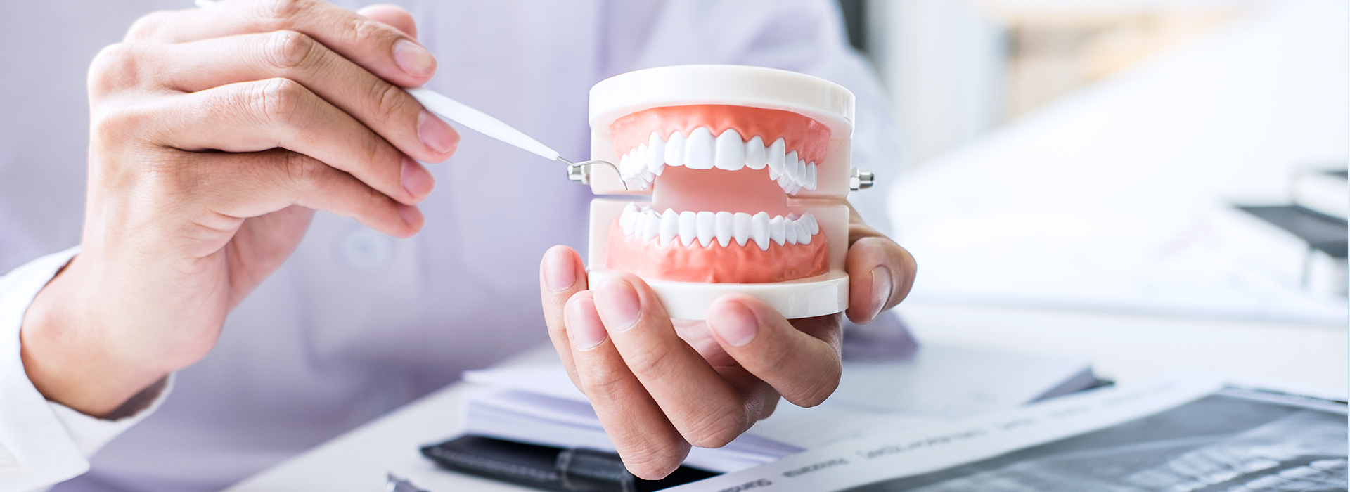 A person holding a coffee cup with a toothbrush and toothpaste inside, set against an office background.